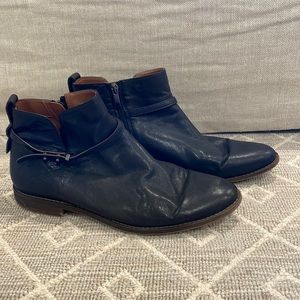 Black leather low height boots with side zipper.